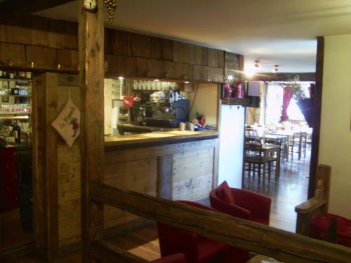 a kitchen with a bar and a dining room at Hôtel Rent in Megève