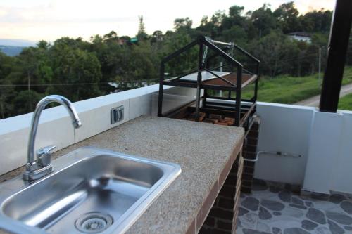 a kitchen counter with a sink and a view at Nueva, Moderna casa en Silvania con Jacuzzi in Silvania
