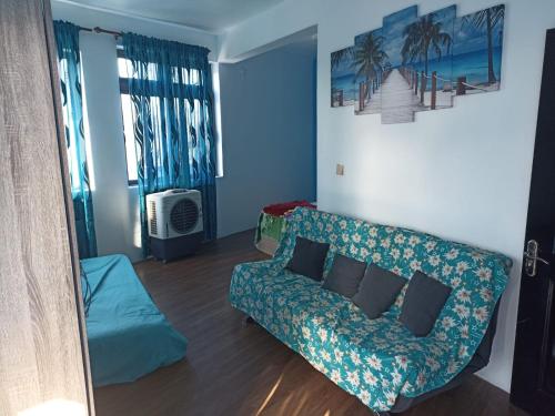a living room with a couch and a bed at R-Villa in Grand Baie