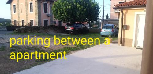 a house with two cars parked in a driveway at Apartma Matjaž in Koper