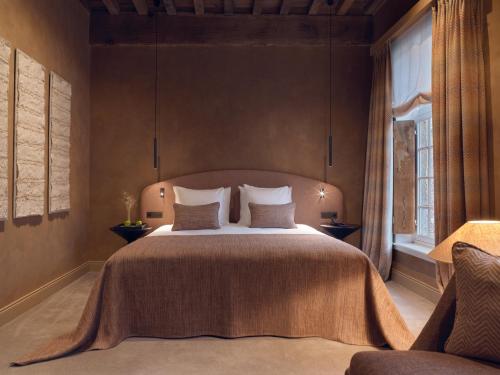 a bedroom with a large bed and a window at Botanic Sanctuary Antwerp - The Leading Hotels of the World in Antwerp