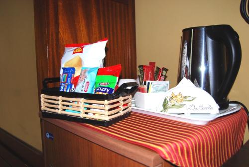a table with a basket of snacks and a coffee maker at Hotel Locanda Da Carla in Vigevano