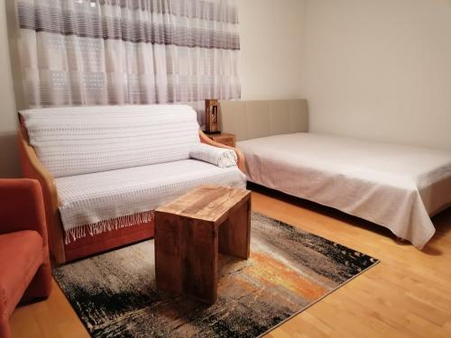 a room with two beds and a coffee table at Apartment GINA in Innsbruck