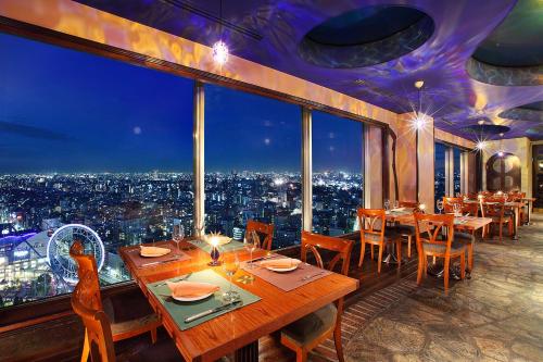 a restaurant with tables and chairs and a large window at Tokyo Dome Hotel in Tokyo