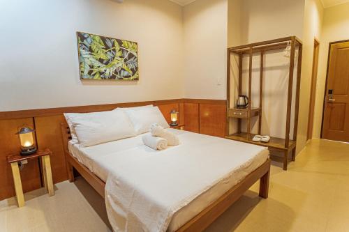 a bedroom with a bed with a towel on it at Marieli Suites near Panglao International Airport in Panglao Island