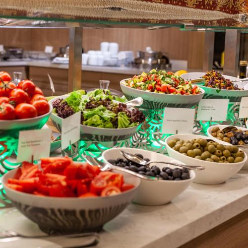 a table with bowls of different types of vegetables at InterContinental Baku by IHG in Baku