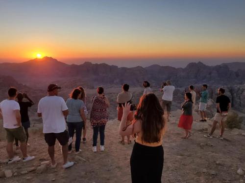 a group of people watching the sunset at the grand canyon at Petra Desert Dream Hotel in Wadi Musa