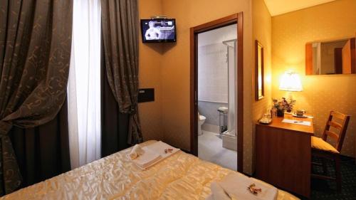 a hotel room with a bed and a bathroom at Vatican Holiday in Rome