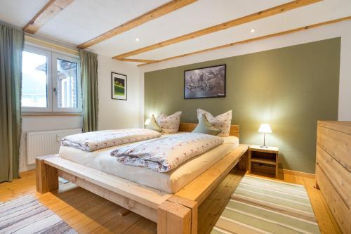 een slaapkamer met een groot bed met een houten frame bij Ferienwohnung Stempfle in Oberstdorf