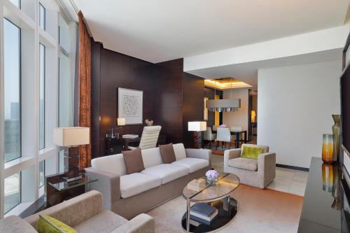 a living room with a couch and a table at Rosewood Abu Dhabi in Abu Dhabi
