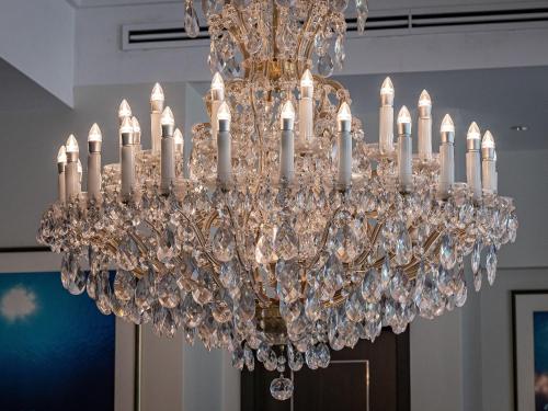 a chandelier with white candles in a room at Okinawa EXES Naha in Naha