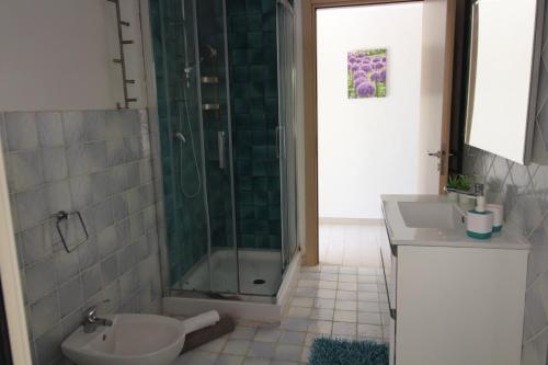 a bathroom with a shower and a toilet and a sink at Anthiros Siracusa in Siracusa