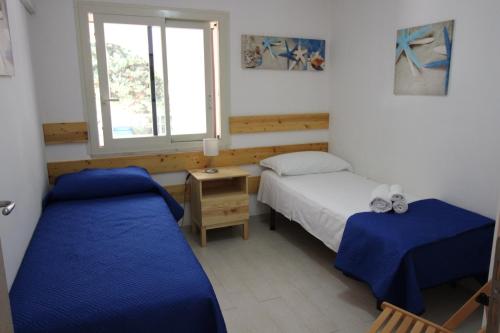 a bedroom with two beds and a window at Anthiros Affitti brevi in Arenella