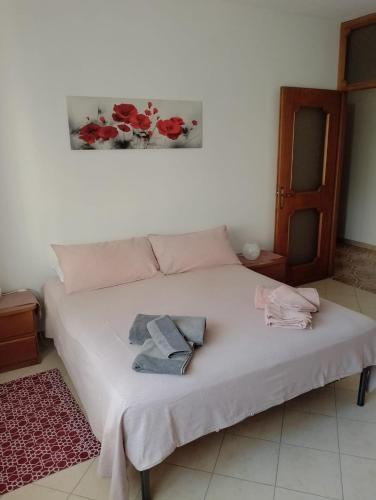 a bedroom with a bed with two ties on it at Il Faggio in Beura