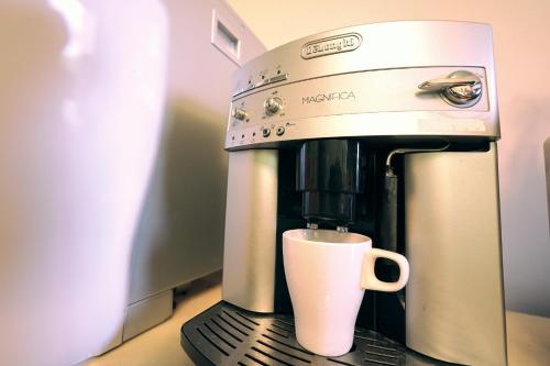 a coffee maker with a cup on a counter at Taitung city-cottage B&B in Taitung City