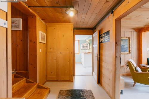 a hallway of a cabin with wood paneled walls at The Farmhouse in Sedrun