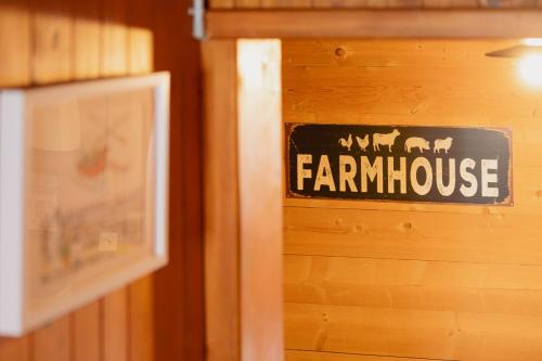 a sign that says farmhouse on a wooden wall at The Farmhouse in Sedrun