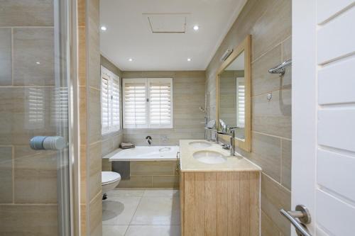 a bathroom with a sink and a toilet at San Lameer Villa - 14014 - 5 Bedroom Luxury - 10 pax - San Lameer Rental Agency in Southbroom
