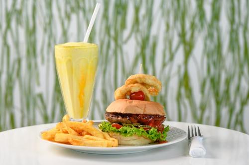 a plate with a burger and fries and a drink at San Lameer Villa - 14014 - 5 Bedroom Luxury - 10 pax - San Lameer Rental Agency in Southbroom