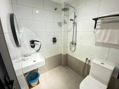 a bathroom with a shower and a toilet and a sink at ARENA Boutique Hotel Kuala Terengganu in Kuala Terengganu