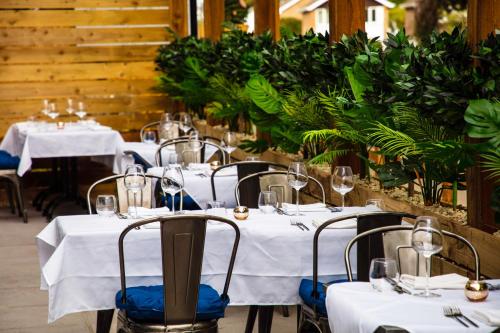 a group of tables with white table cloths and chairs at The Charlton Boutique Hotel in Cheltenham