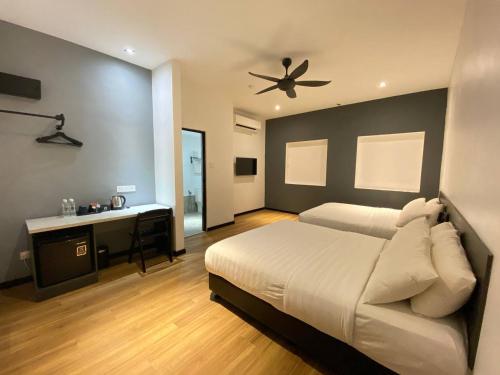 a bedroom with a bed and a ceiling fan at ARENA Boutique Hotel Kuala Terengganu in Kuala Terengganu