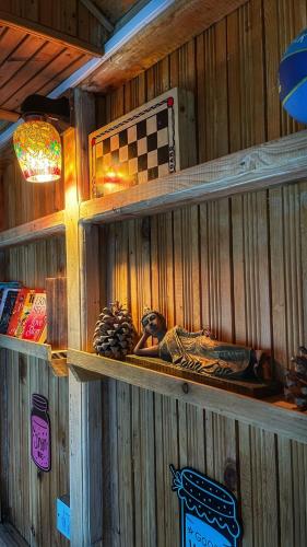 a wooden wall with shelves in a room at The Misty Wilds Home, Jibhi in Jibhi