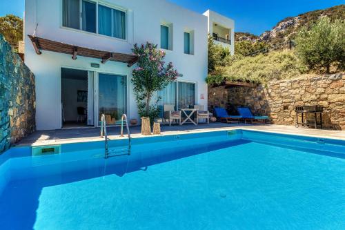 a villa with a swimming pool and a house at Istron Collection Villas in Istron