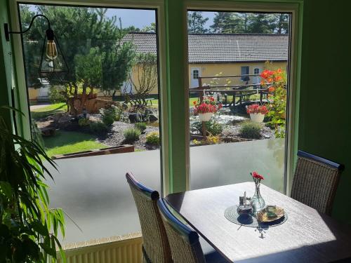 a table and chairs in front of a window at Hotel Pommerscher Hof in Zinnowitz
