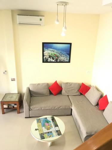 a living room with a couch and a table at Hoi An beach house in Hoi An