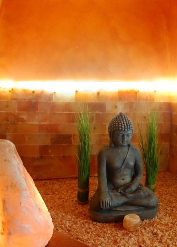a statue sitting on the floor next to some plants at Terra Mia Suite in Catania