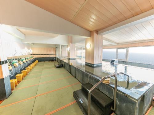 a large room with a view of the ocean at Atagawa Onsen Blue Ocean in Higashiizu