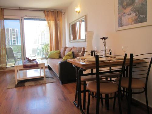a living room with a table and a couch at Nomi Suites Marina Herzelia in Herzelia 