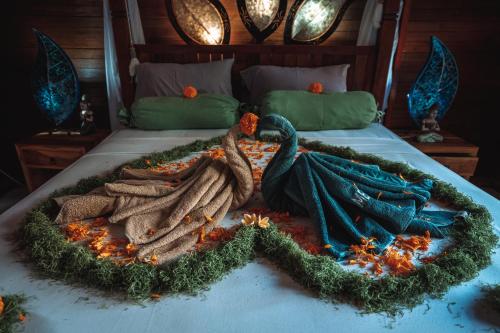 a bed with a decoration of a peacock on it at Aroma De La Mer in Amed