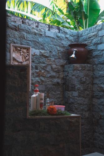 a bathroom with a shelf with a bottle of soap at Aroma De La Mer in Amed