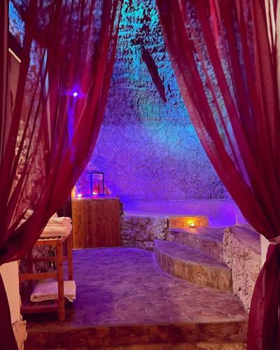 a stage with red curtains and stairs in a room at B&B La Sorgente in Brindisi