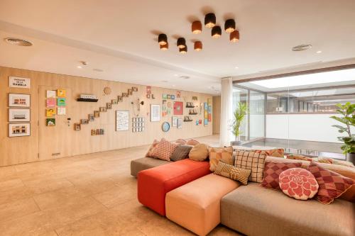 a living room filled with furniture and a couch at Citadines Ramblas Barcelona in Barcelona