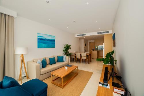 a living room with a couch and a table at The Ocean Villas Managed by The Ocean Resort in Da Nang