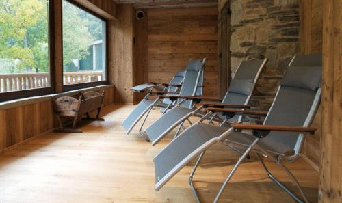 a row of chairs sitting in a room with windows at Relais Del Nazionale in Vernante