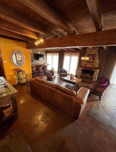 a large living room with a couch and a table at Beautiful Cabin Downtown Tapalpa Oven Mud Barbecue Grill 4 Room 12 ppl TV Wifi in Tapalpa
