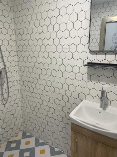 a bathroom with a sink and a mirror at Timehouse Hong Kong Hostel Group in Hong Kong