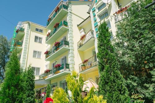 a tall white building with plants in front of it at SPA Villa Jasmin in Truskavets
