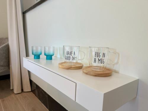 two coffee mugs sitting on a white table at Tuss in Kortrijk
