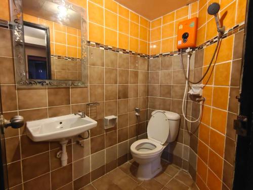 a bathroom with a toilet and a sink at Wualai Boutique by Lanna Oriental in Chiang Mai