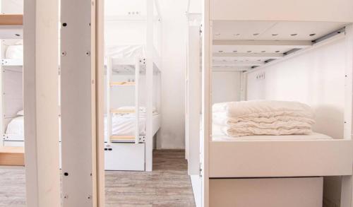 a room with two bunk beds in it at Hostellicious in Faro
