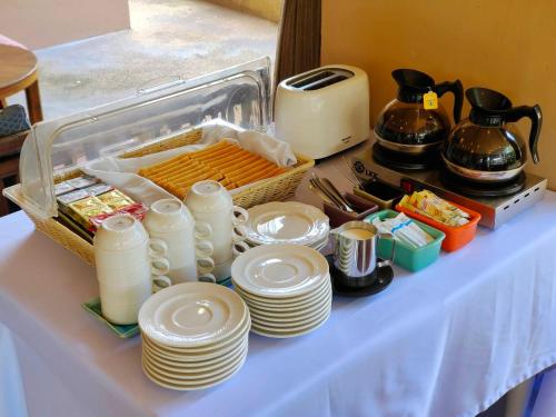 a table with white plates and a basket of food at Wualai Boutique by Lanna Oriental in Chiang Mai