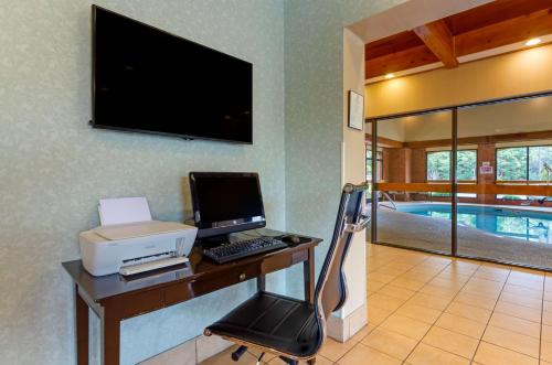 a desk with a computer and a printer and a pool at Best Western Staunton Inn in Staunton