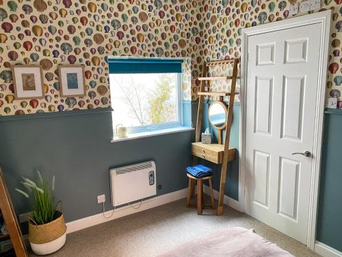 a room with a bed and a mirror and a window at The Garden Flat in Exmouth