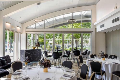 a room with tables and chairs and a large window at The Terrace Hotel Adelaide in Adelaide