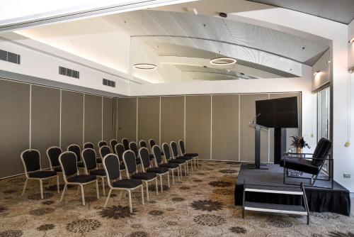 a conference room with chairs and a flat screen tv at The Terrace Hotel Adelaide in Adelaide